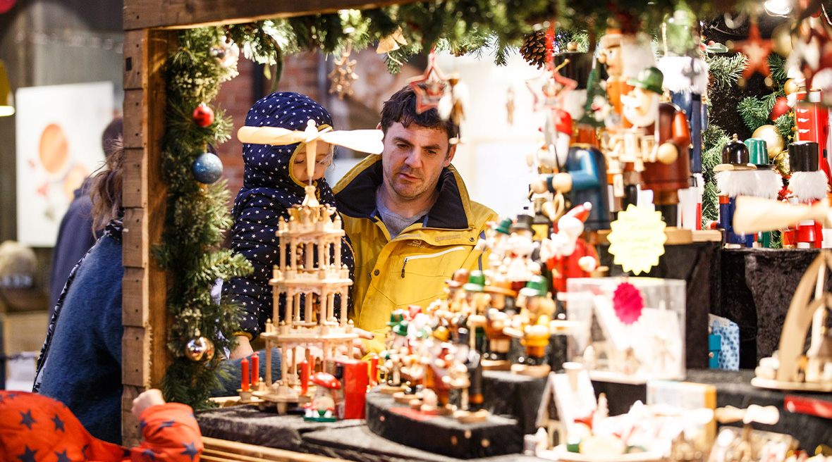 A man and child exploring the Canterbury Christmas Markets