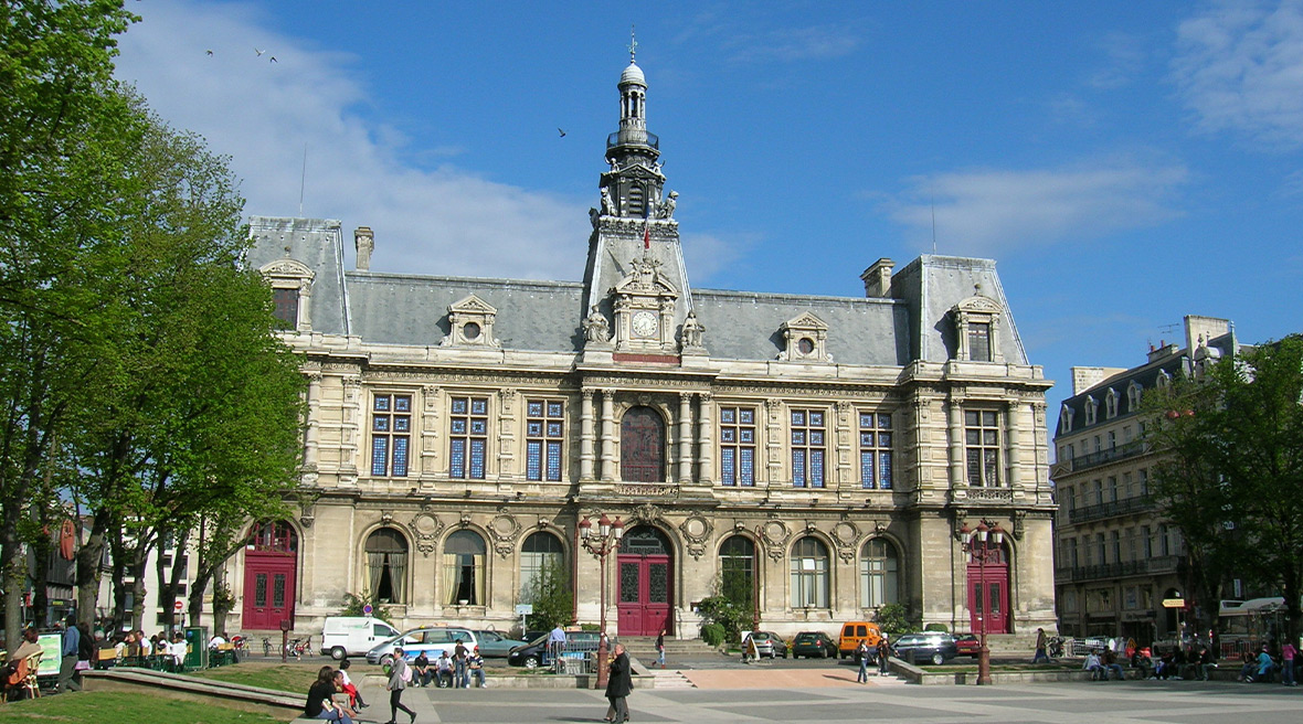 A grand municipal building in a large square