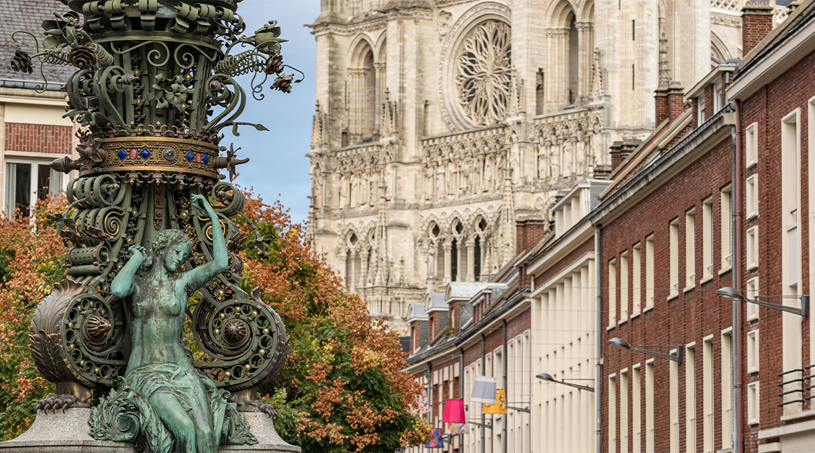 Marie-sans-Chemise statue in Amiens city centre with gothic architecture in the background