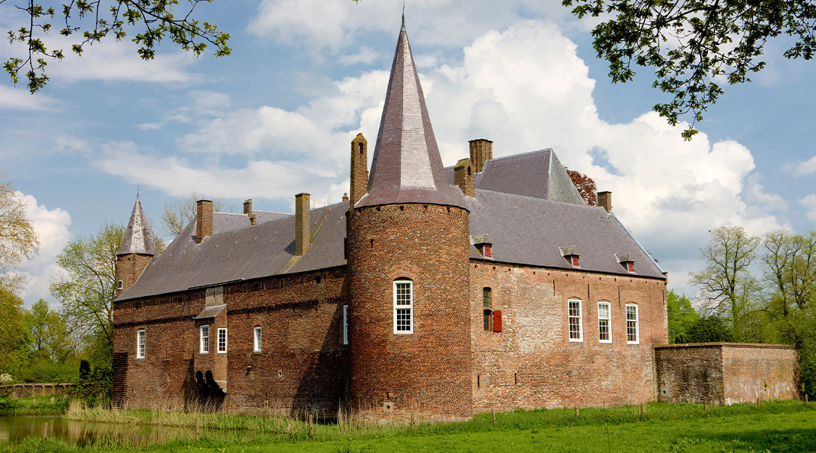 A castle type building with modern windows and round corner towers