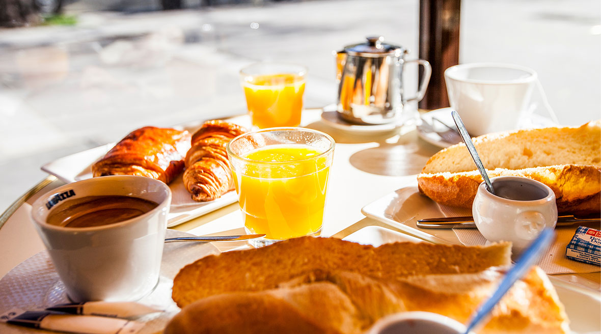 Full breakfast including orange juice, coffee, and pastries