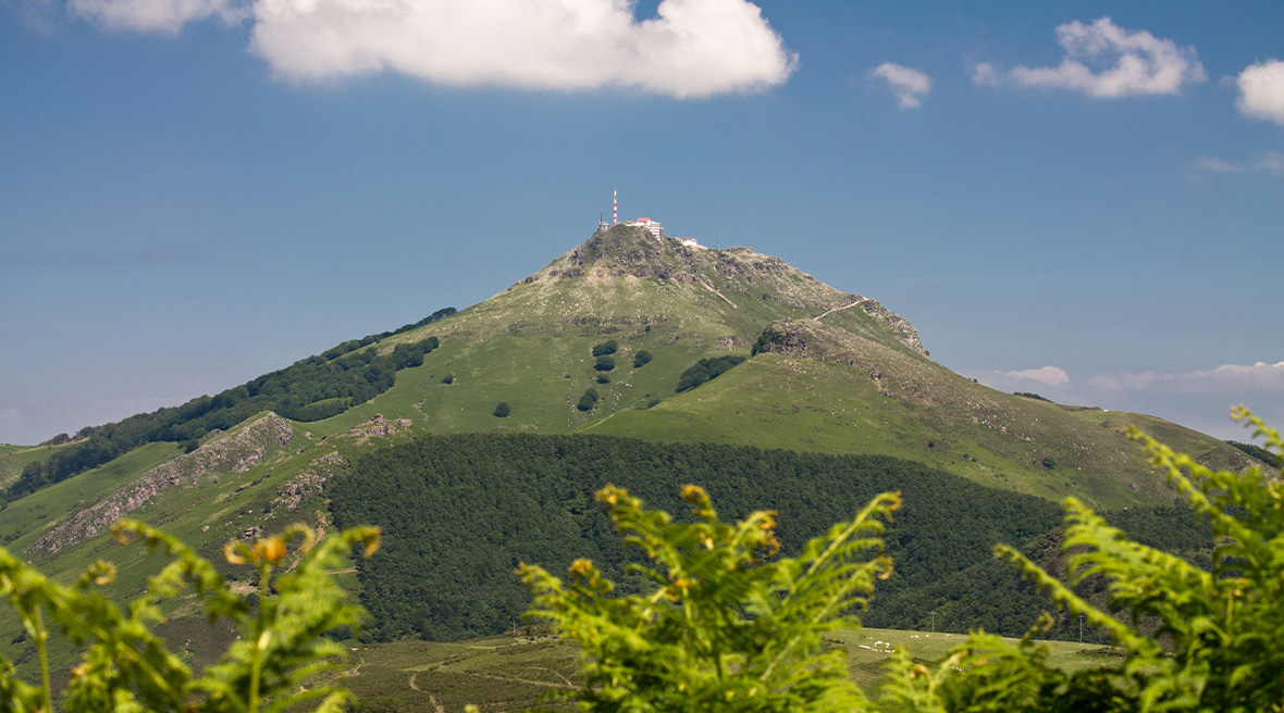 Mountain with buildings and a communication tower at the summit