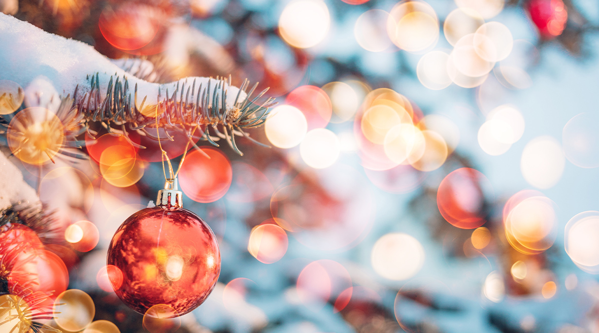Close-up van een kerstboom met lichtjes en versieringen.