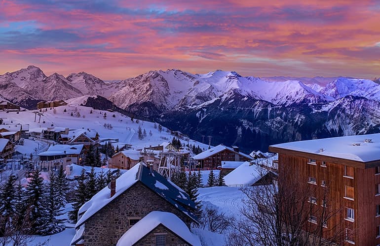 Evening Sunset At Ski Resort Village, Chamonix Mont-Blanc over snow covered buildings