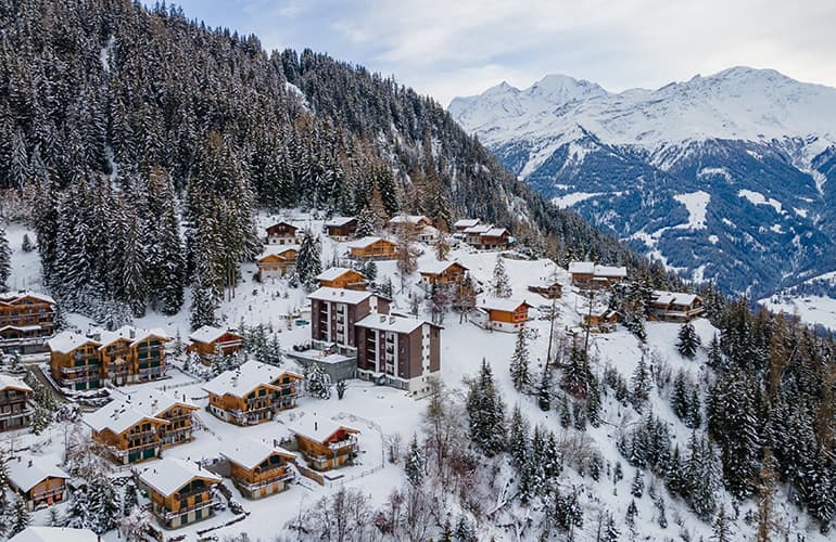 Snow-capped village of Verbier surrounded by mountains and trees