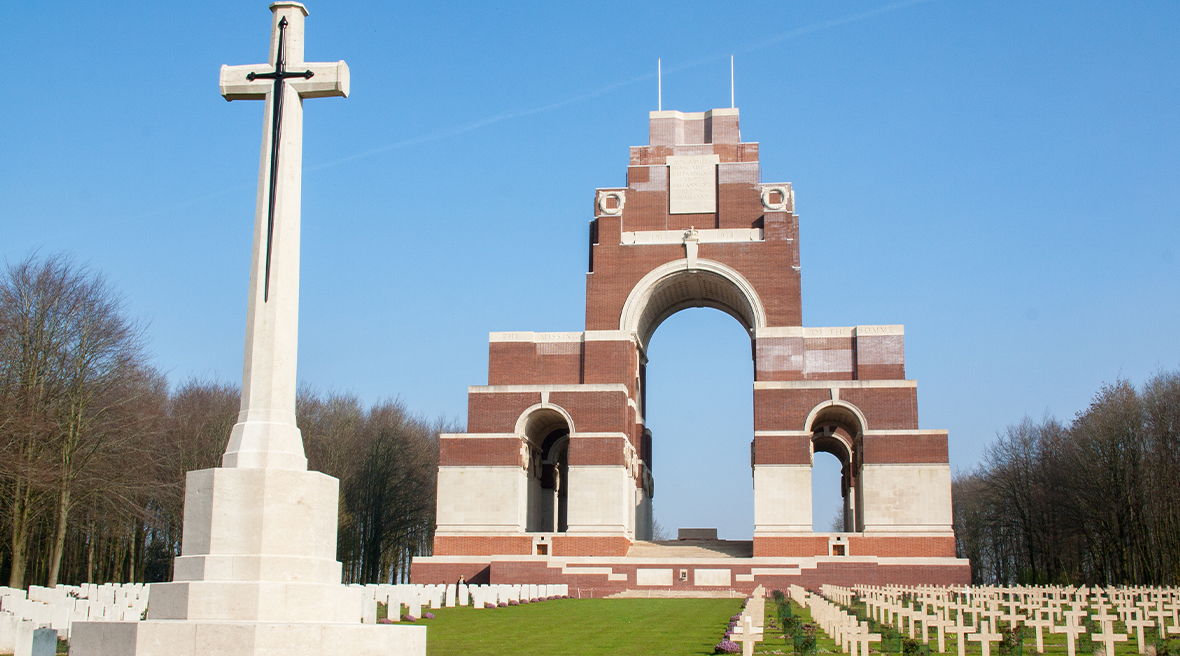 Thiepval Memorial with military cemetery and monumental cross in front of it
