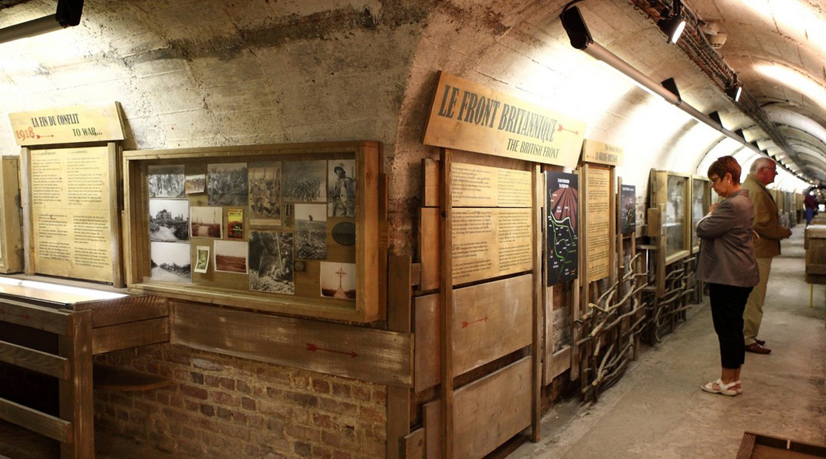 Visitors in a museum looking at displays showing Great War artefacts