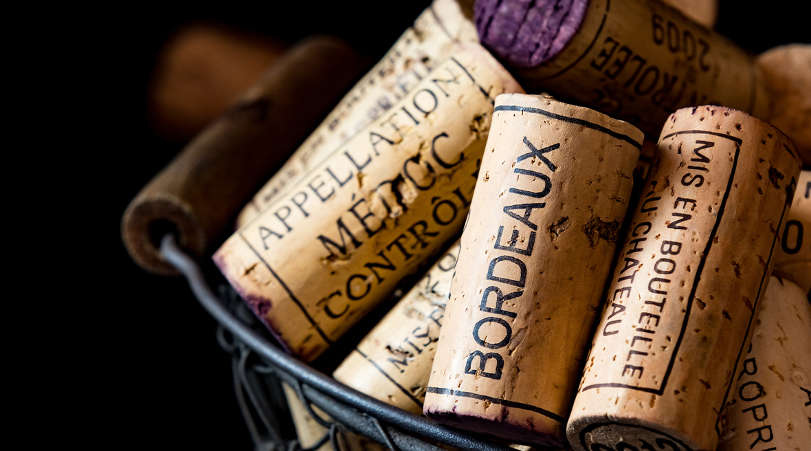 Used wine corks in a basket, with wine regions imprinted on them, such as Bordeaux